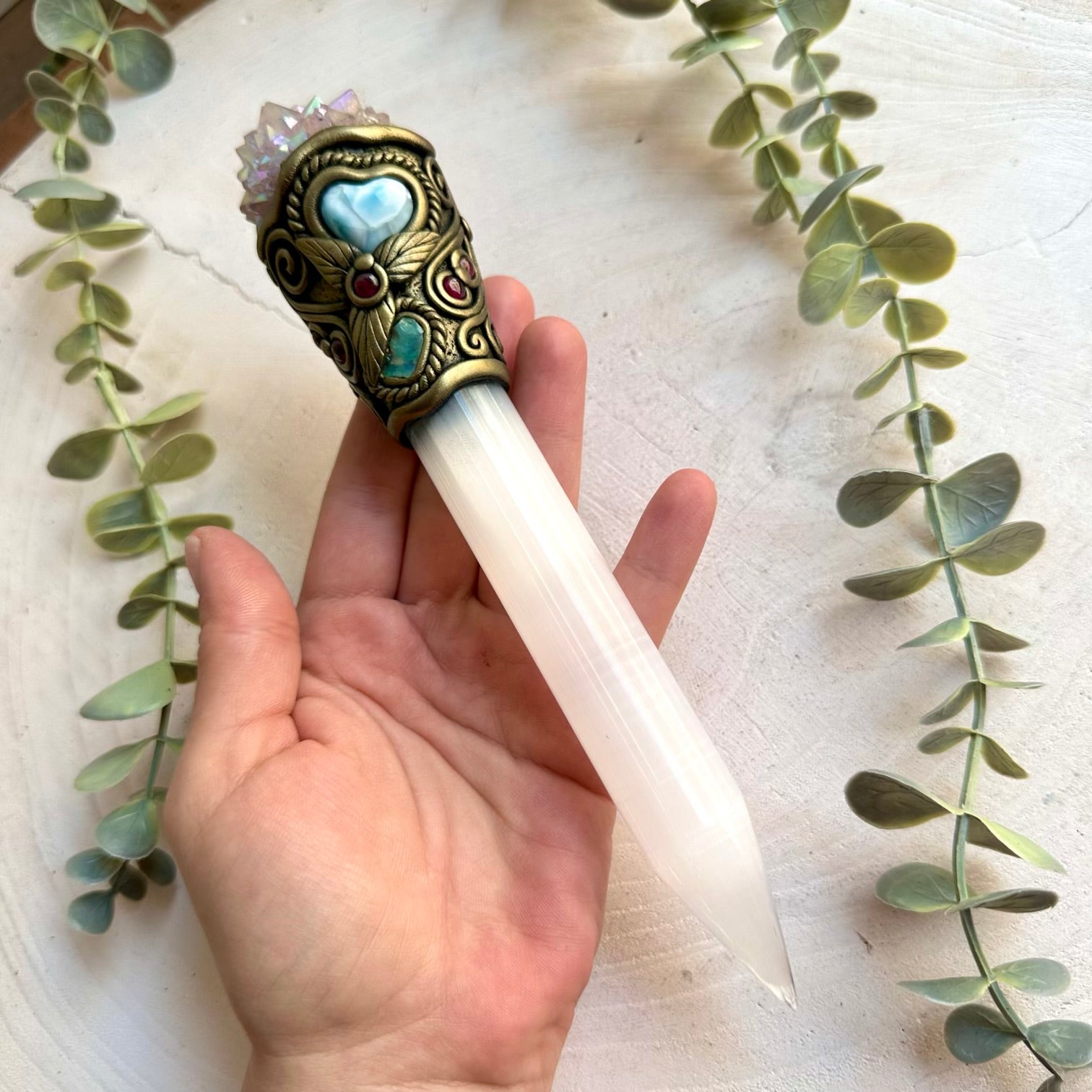 Handmade Selenite crystal wand featuring Angel Aura Spirit Quartz, Ethiopian Opal, Larimar Heart and Rhodolite Garnet. A one of a kind energy healing tool combining luminous Selenite with iridescent crystals and natural gemstones.