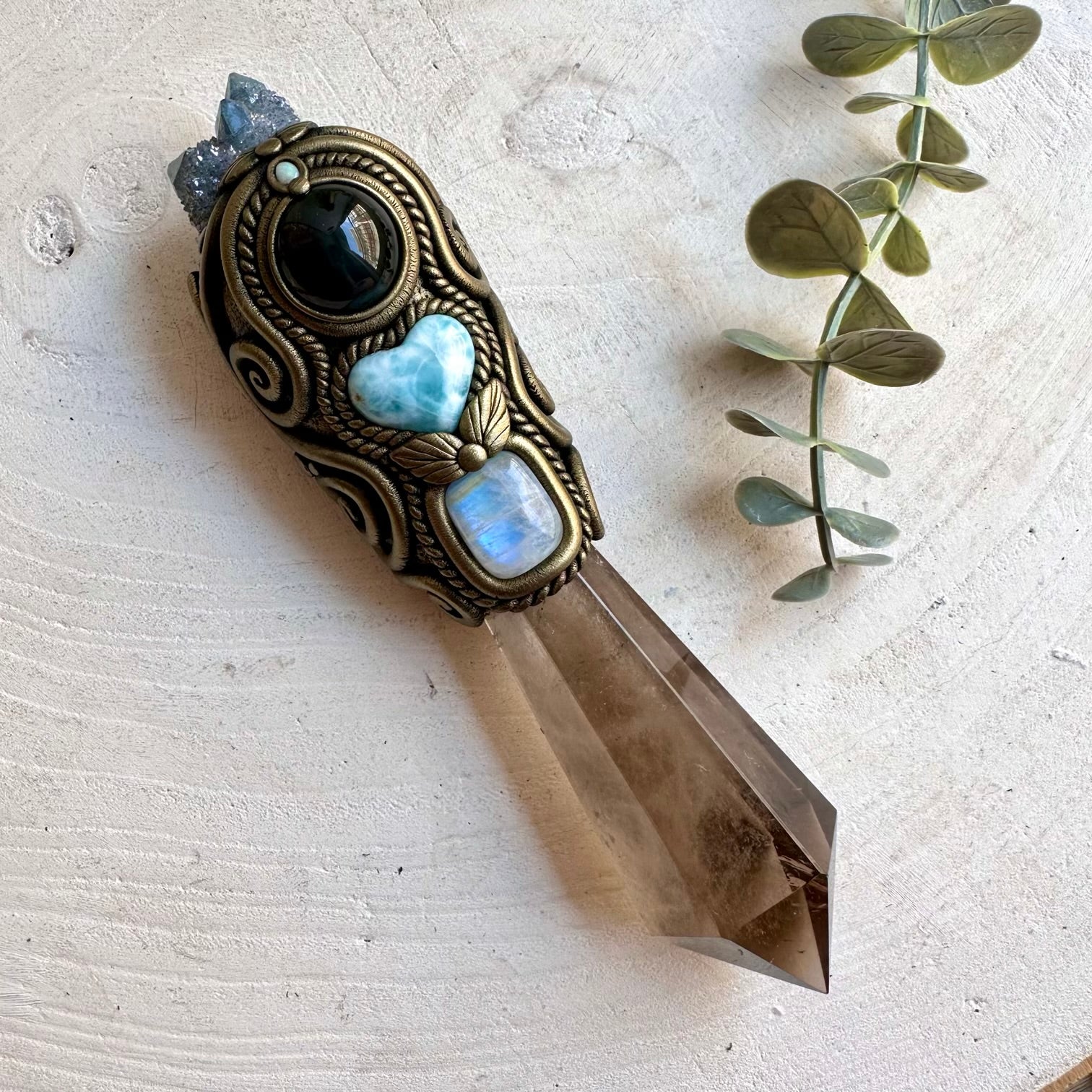 Handmade Smoky Quartz crystal wand featuring an Aqua Aura Spirit Quartz Cluster, Larimar Heart, Rainbow Obsidian, Rainbow Moonstone and Australian Opal one of a kind metaphysical healing crystal tool designed for meditation, energy work, manifestation, Wiccan rituals and Pagan altar practice.