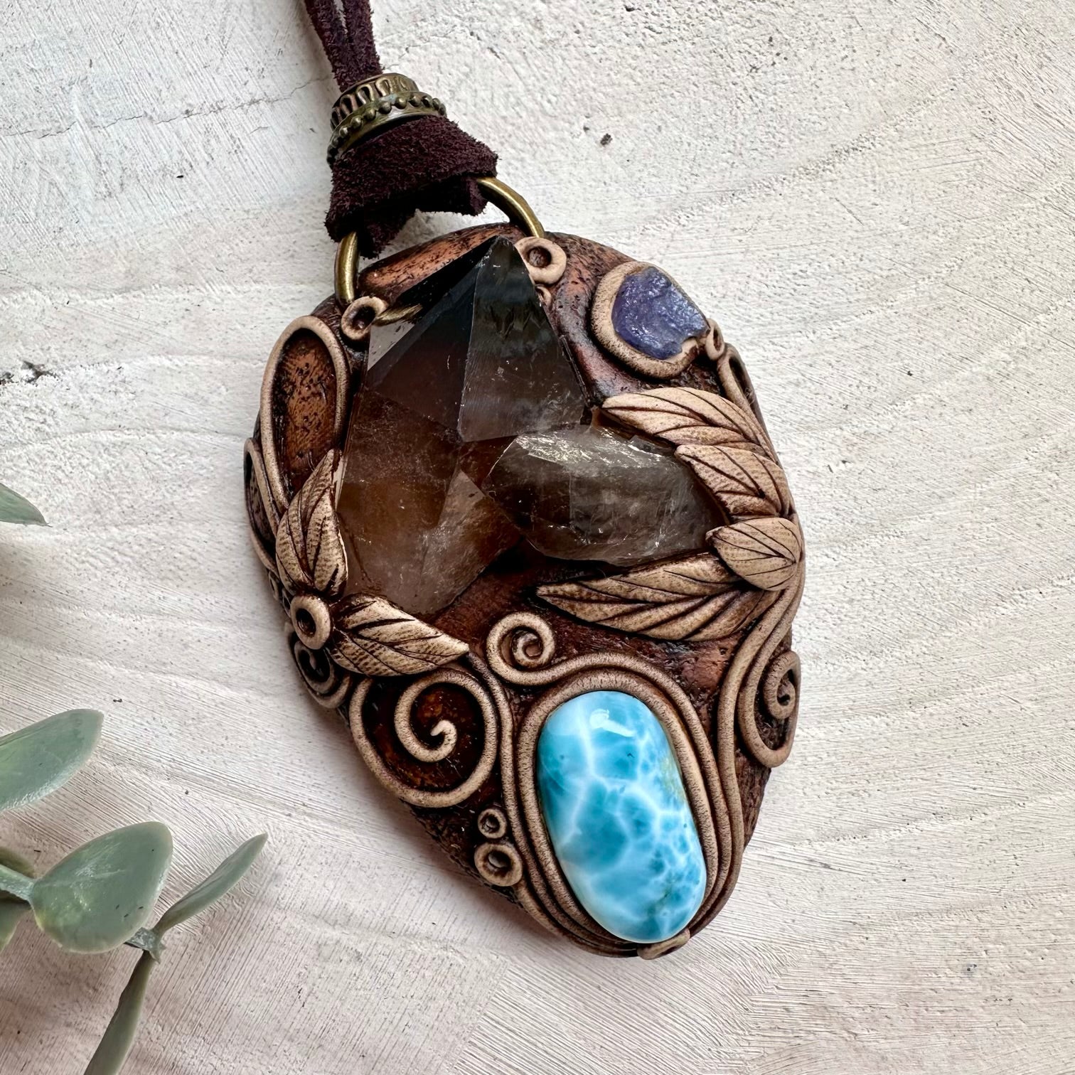 Smoky quartz cluster paired with larimar and tanzanite in a necklace
