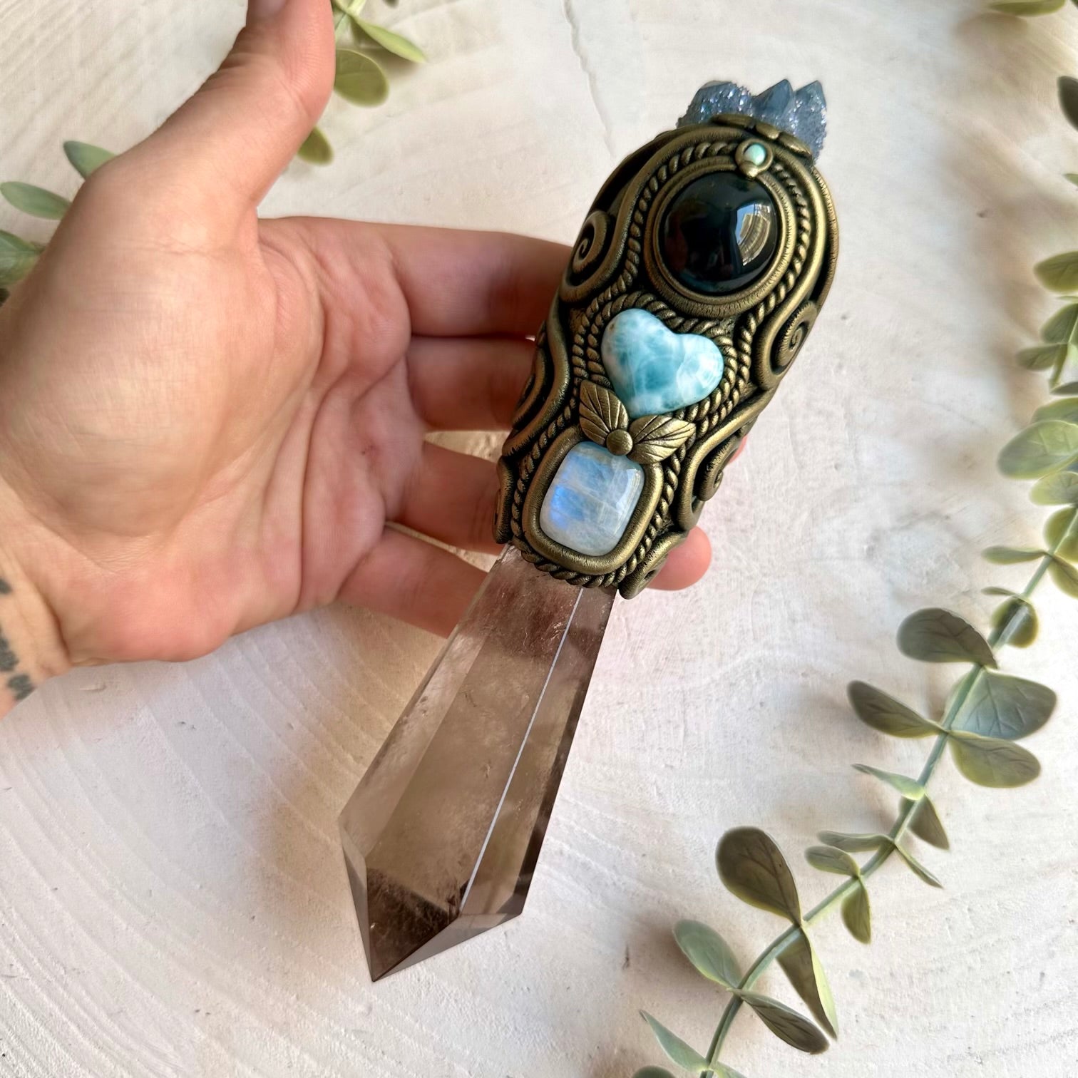 Handmade Smoky Quartz crystal wand featuring an Aqua Aura Spirit Quartz Cluster, Larimar Heart, Rainbow Obsidian, Rainbow Moonstone and Australian Opal designed for meditation, energy work, manifestation, Wiccan rituals and Pagan altar practice.