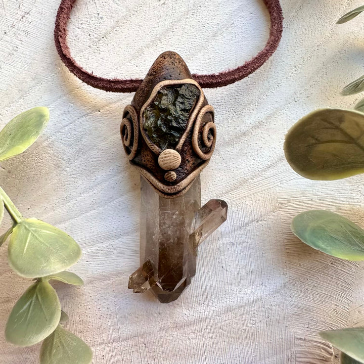 Spiritual pendant featuring raw moldavite and smoky quartz