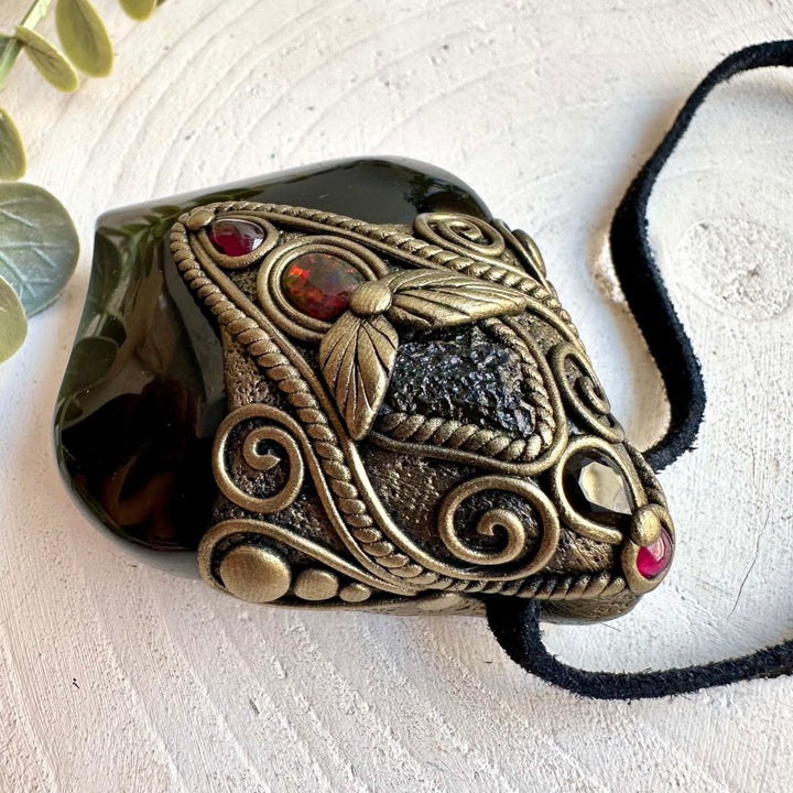 Natural gemstone pendant showcasing the subtle colors of Rainbow Obsidian with Rhodolite Garnet.