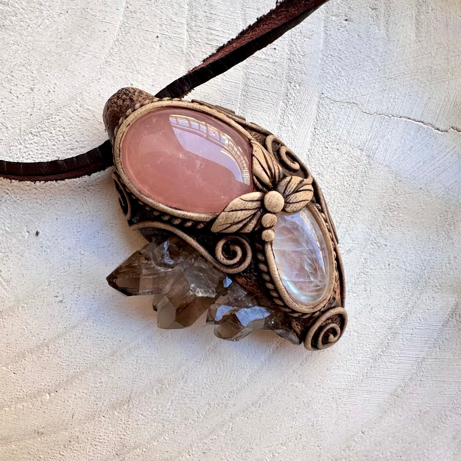 Smoky quartz cluster paired with rose quartz and rainbow moonstone