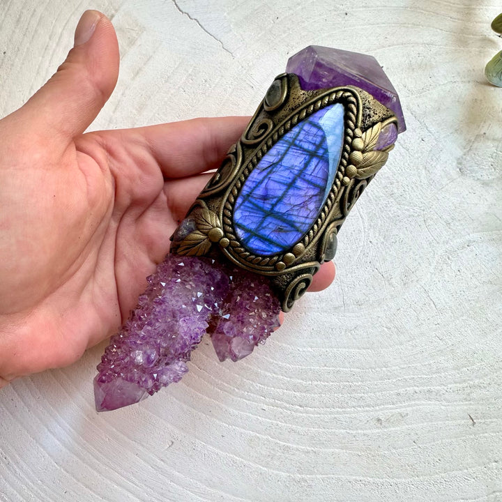 Handmade healing crystal wand featuring Spirit Quartz, Amethyst, Purple Labradorite, Charoite, Tanzanite and Clear Topaz. A one of a kind energy and ritual tool crafted with genuine natural crystals and gemstones, created for meditation, intention setting, spiritual practice and personal transformation.