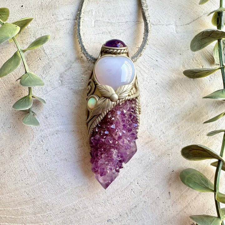 Handmade Spirit Quartz crystal wand and pendant necklace featuring a Blue Chalcedony Heart, Amethyst and Ethiopian Opal. A one of a kind healing crystal tool combining sparkling quartz formations with soft blue, purple and iridescent gemstones, created for meditation, energy work, intention setting and spiritual practice.