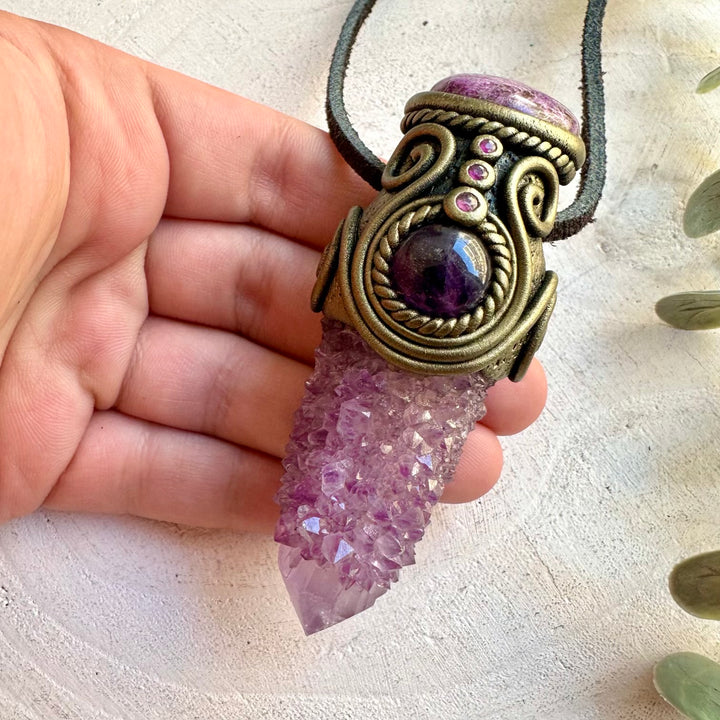One of a kind crystal pendant featuring sparkling Spirit Quartz with purple Amethyst and Ruby.