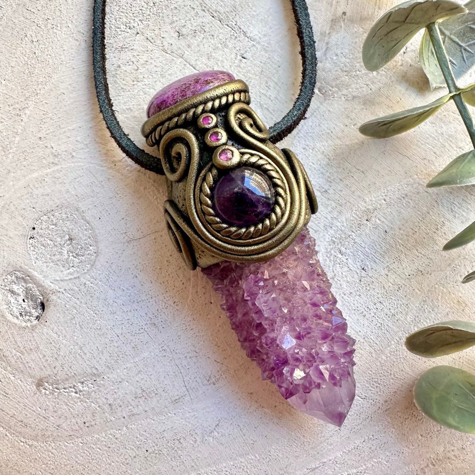 Handmade Spirit Quartz healing crystal pendant necklace featuring Stichtite, Amethyst and Ruby. A one of a kind spiritual jewelry piece combining sparkling crystal formations with soft pink, purple and red gemstones, created as a meaningful crystal tool for meditation, intention setting, inner peace and personal growth.