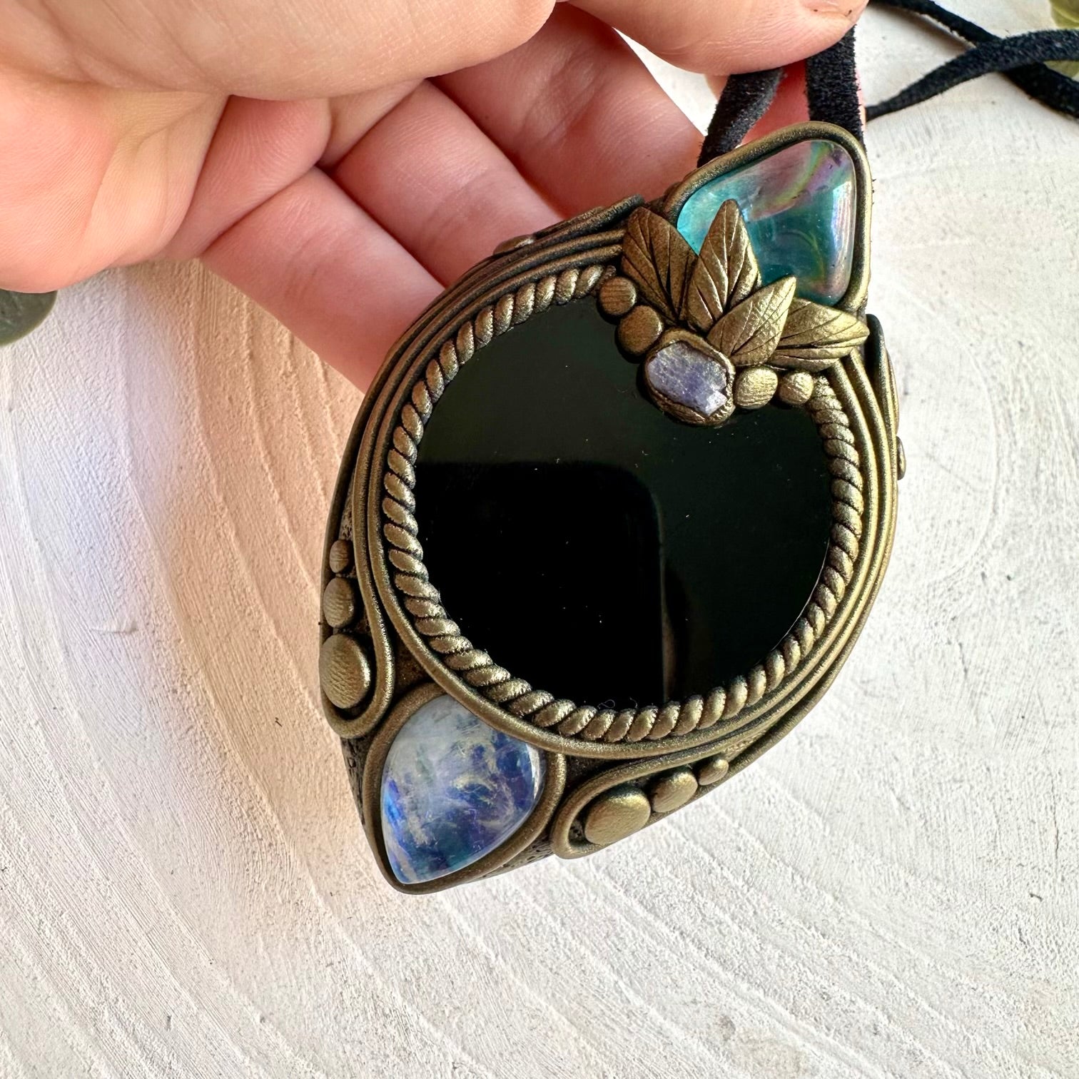 Unique crystal necklace combining a dark Black Obsidian Mirror with luminous Aqua Aura Quartz.