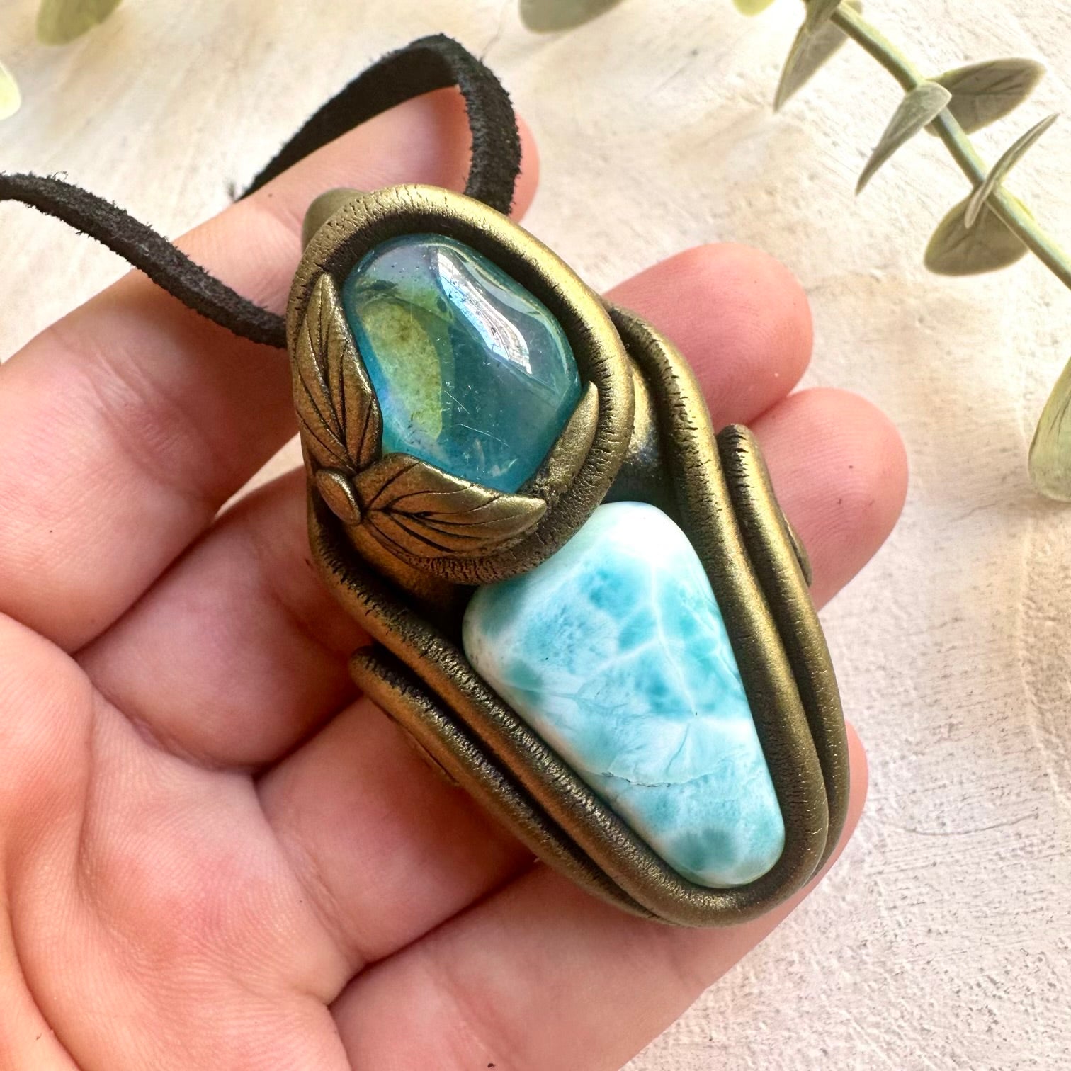 Metaphysical crystal amulet necklace featuring Larimar and shimmering Aqua Aura Quartz.
