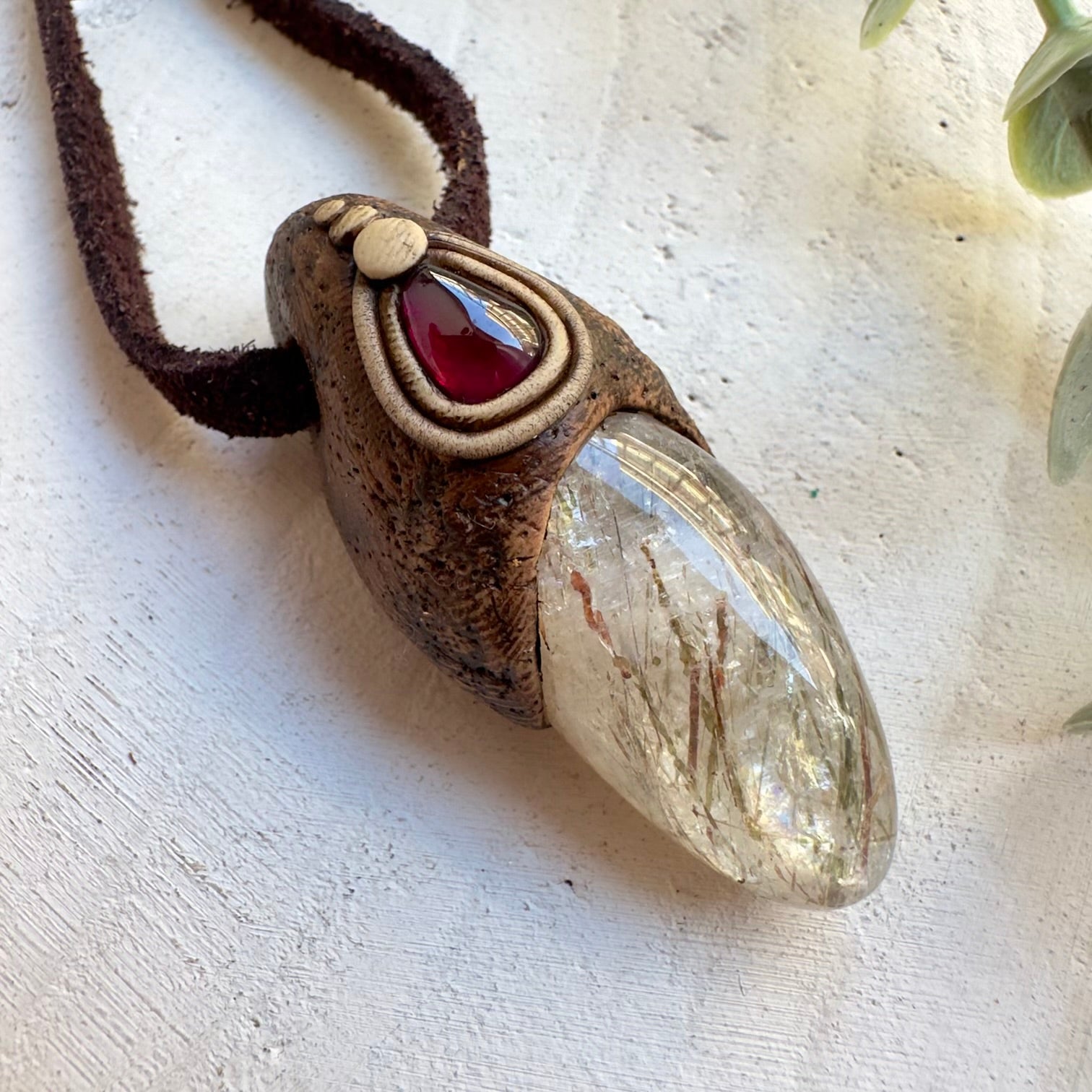 Rhodolite garnet gemstone pendant with healing crystals