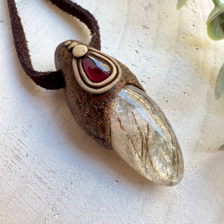 Rhodolite garnet gemstone pendant with healing crystals