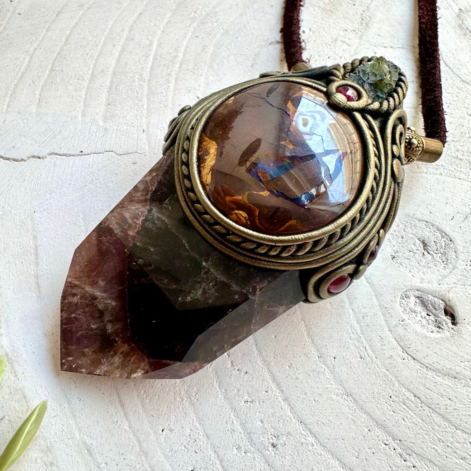 Spiritual crystal pendant featuring Super Seven Quartz with Rhodolite Garnet and natural gemstone accents.