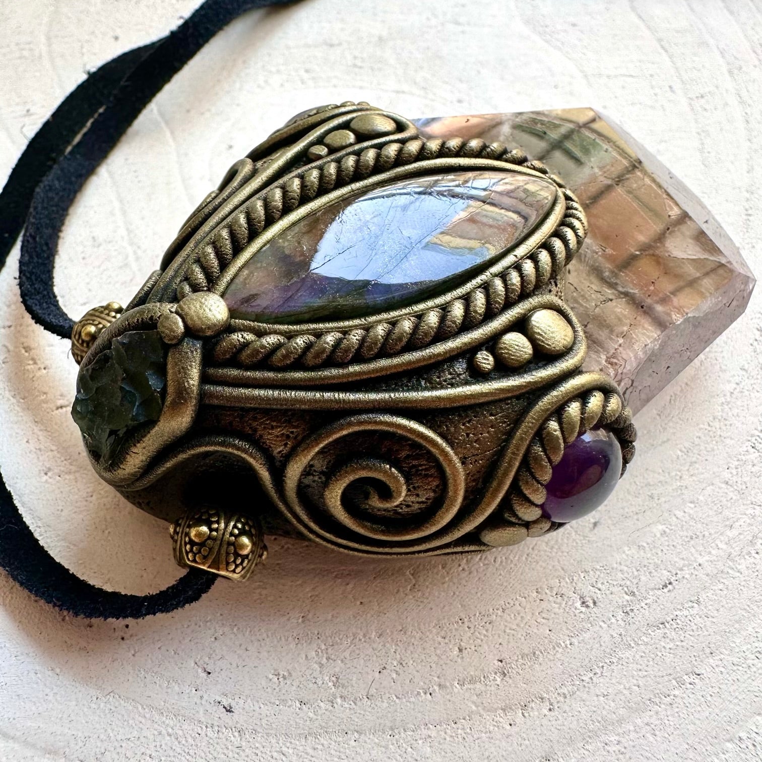 Statement crystal pendant combining Super Seven Quartz with rare natural gemstones.