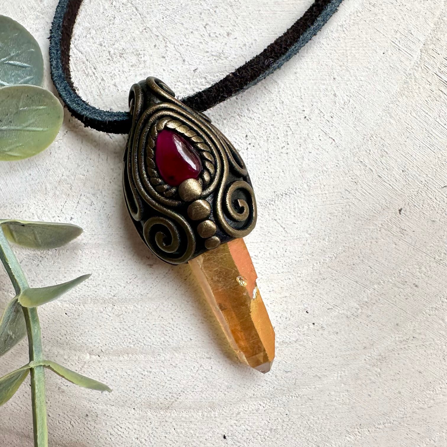 Fantasy-inspired healing crystal necklace with shimmering Sunset Aura Quartz and deep red Garnet gemstones.