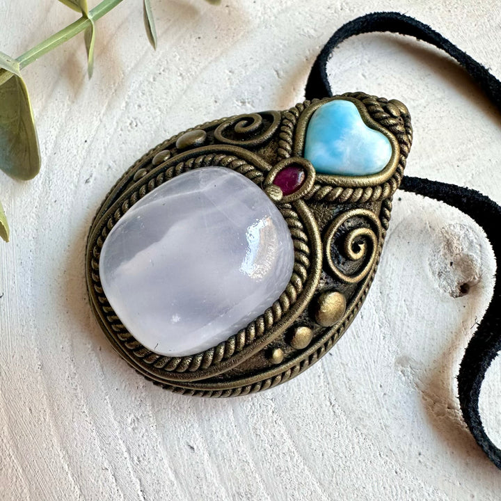 Unique necklace featuring soft golden Mango Calcite, an ocean-blue Larimar Heart and deep red Garnet.