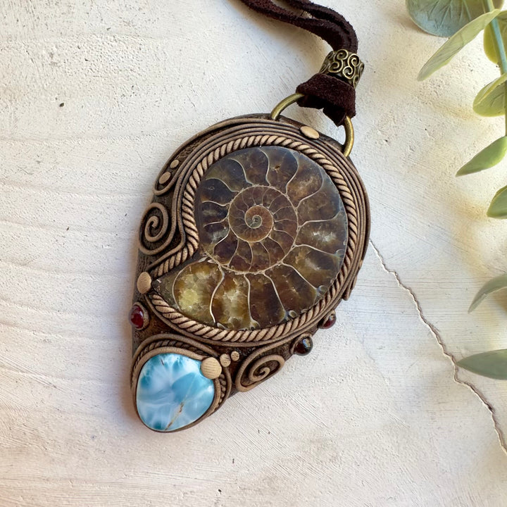 Handmade protection amulet necklace featuring a large ammonite fossil