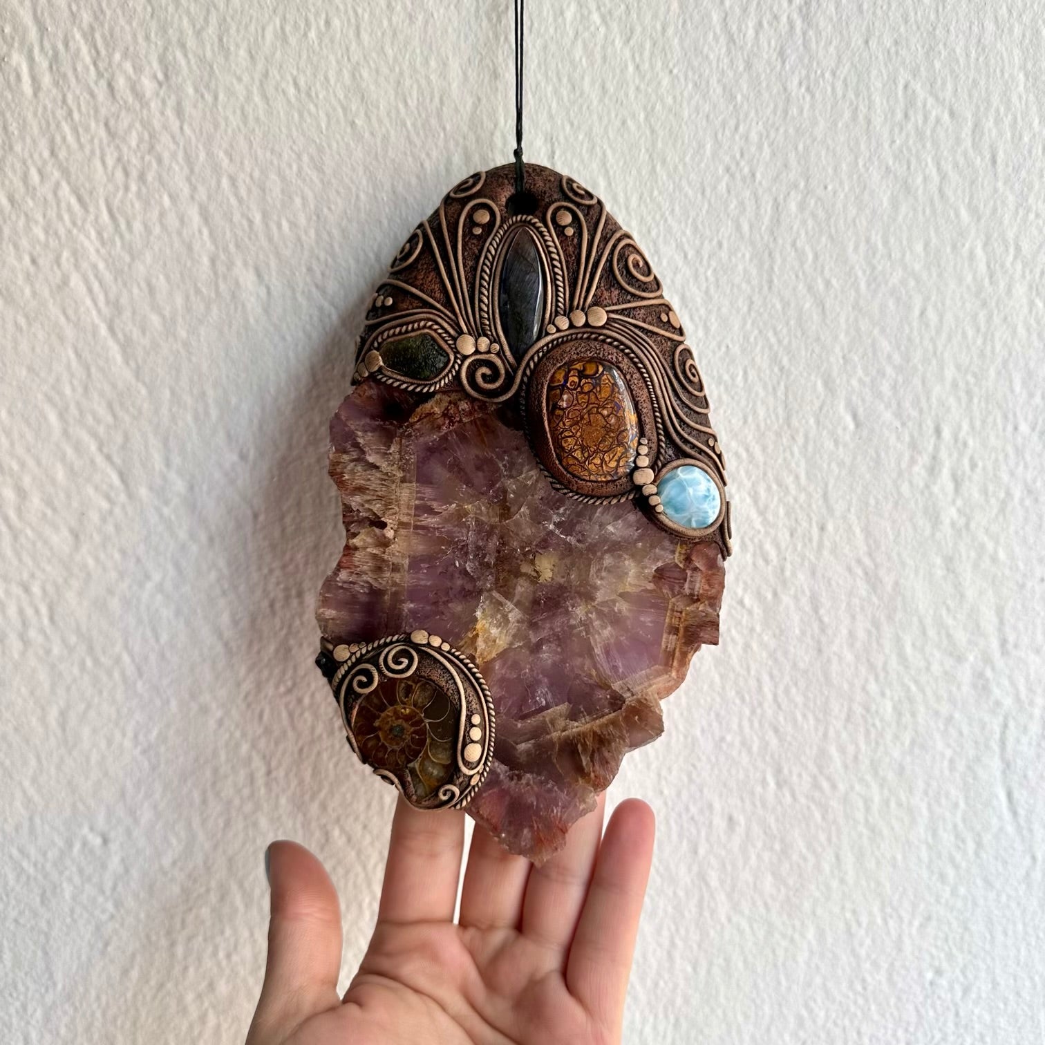 Handmade crystal wall hanging with Super Seven quartz boulder opal ammonite and moldavite