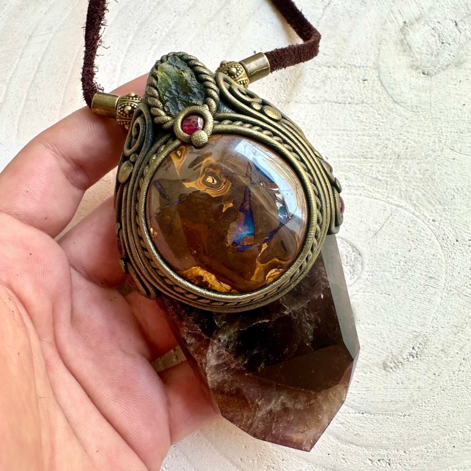 Spiritual crystal pendant featuring Super Seven Quartz with Rhodolite Garnet and natural gemstone accents.