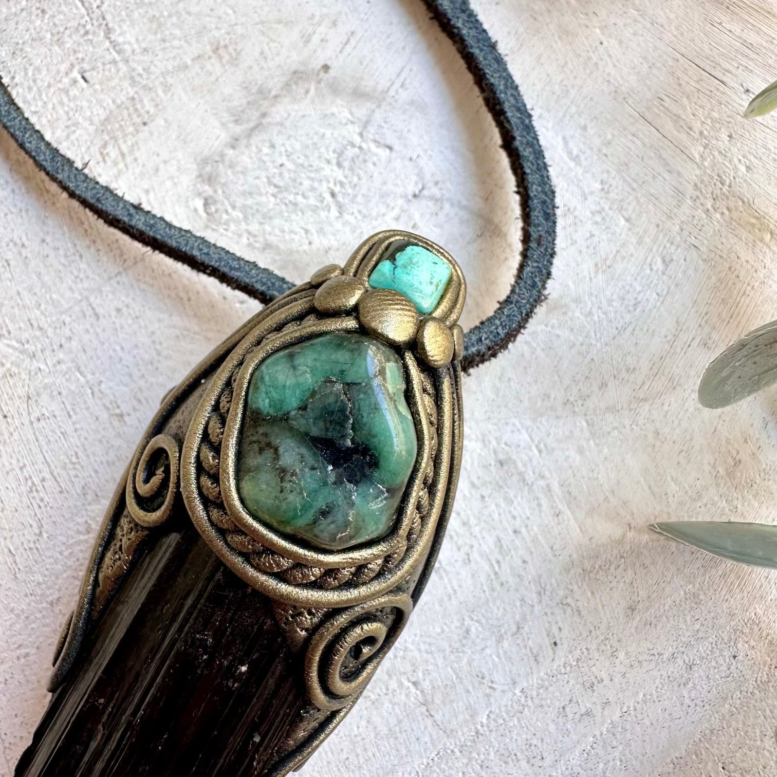 Natural gemstone pendant with Black Tourmaline, deep green Emerald and turquoise-blue stone details.