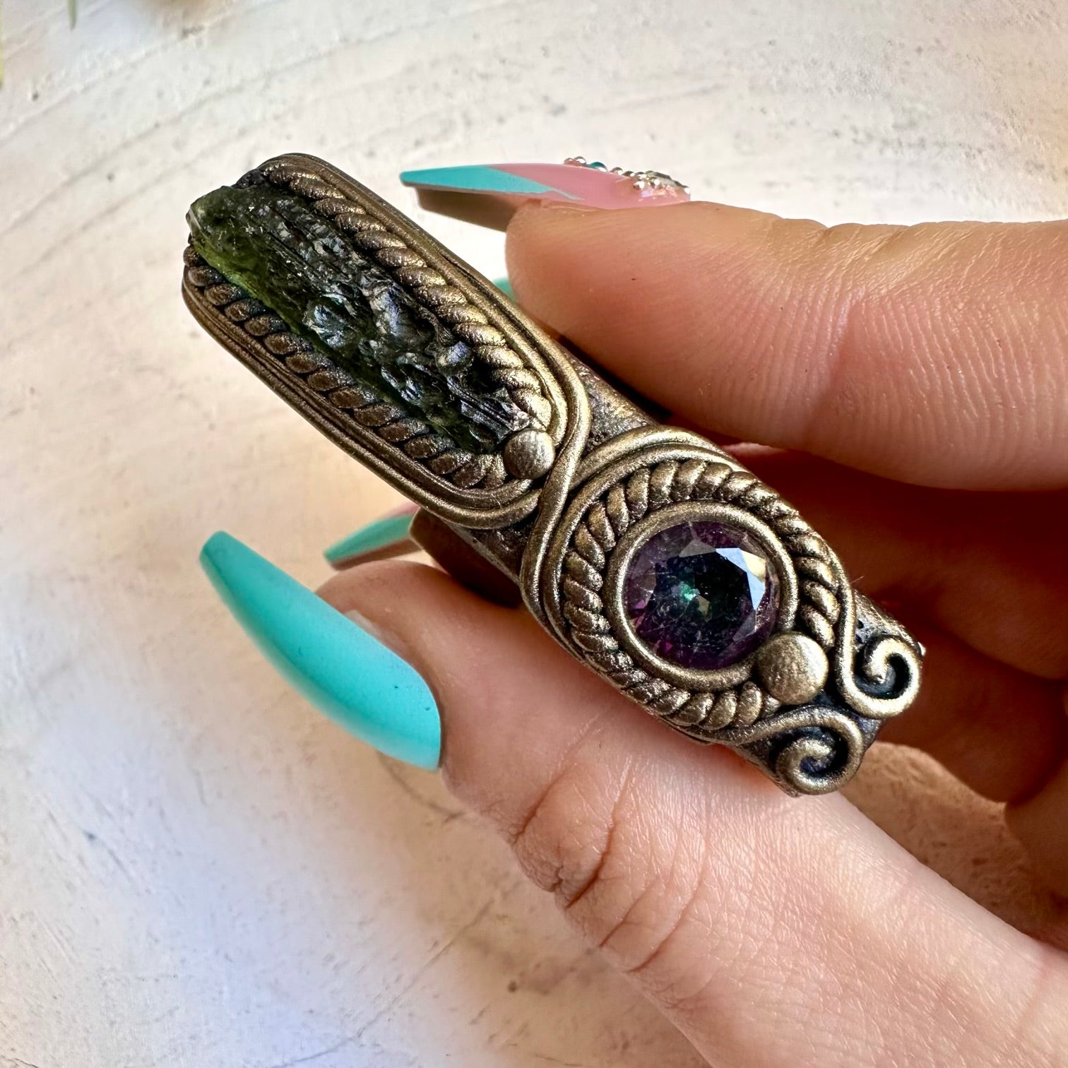 Close up of moldavite and mystic topaz ring
