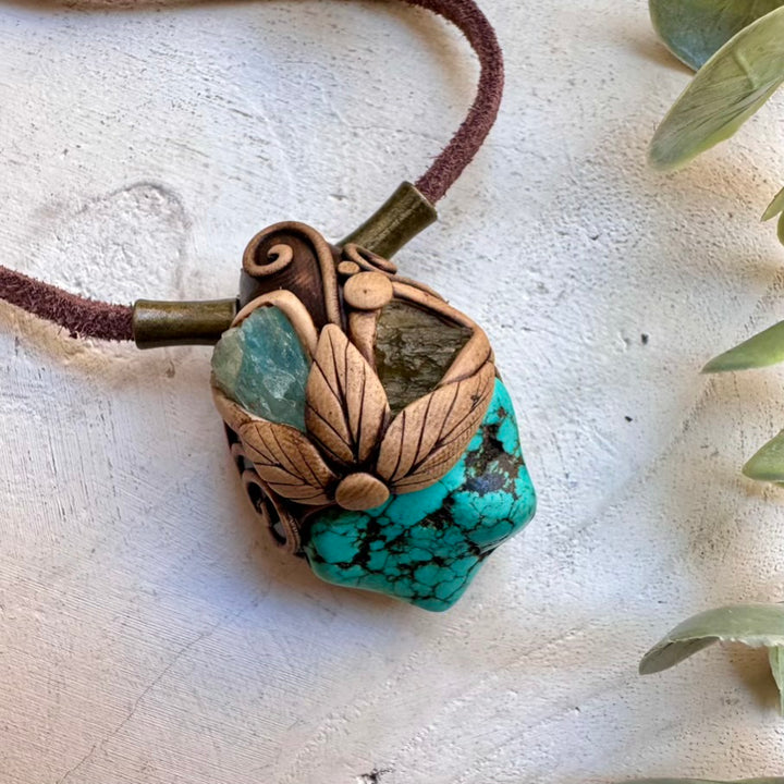 Natural turquoise paired with raw aquamarine and moldavite