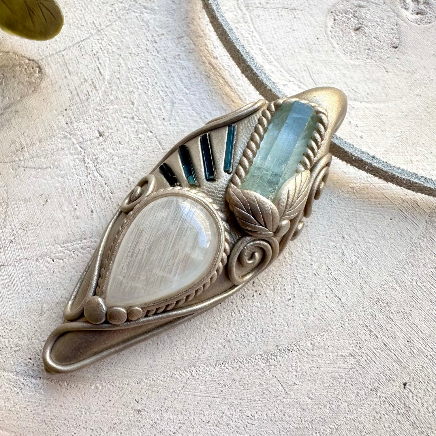 Aquamarine paired with blue tourmaline and moonstone in a necklace