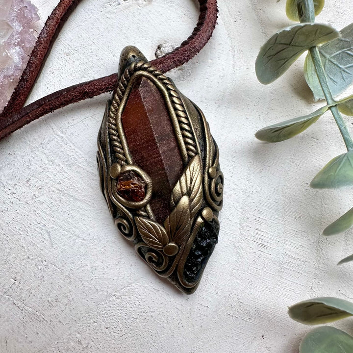 Red quartz paired with moldavite and hessonite garnet