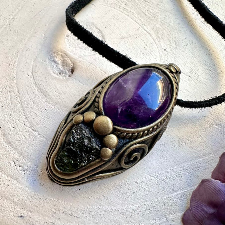 Unisex metaphysical healing crystal necklace featuring natural imperfect raw Moldavite and calming Amethyst pendant.