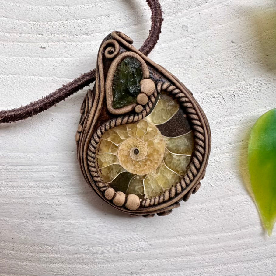 Ammonite fossil pendant paired with natural Moldavite crystal