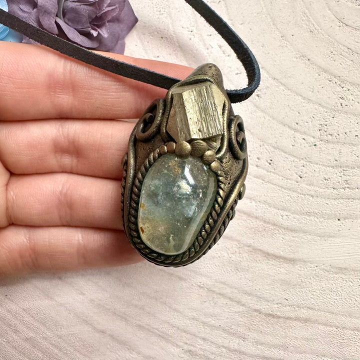 Ethically sourced Topaz gemstone with radiant raw Pyrite crystal, protective metaphysical jewelry.