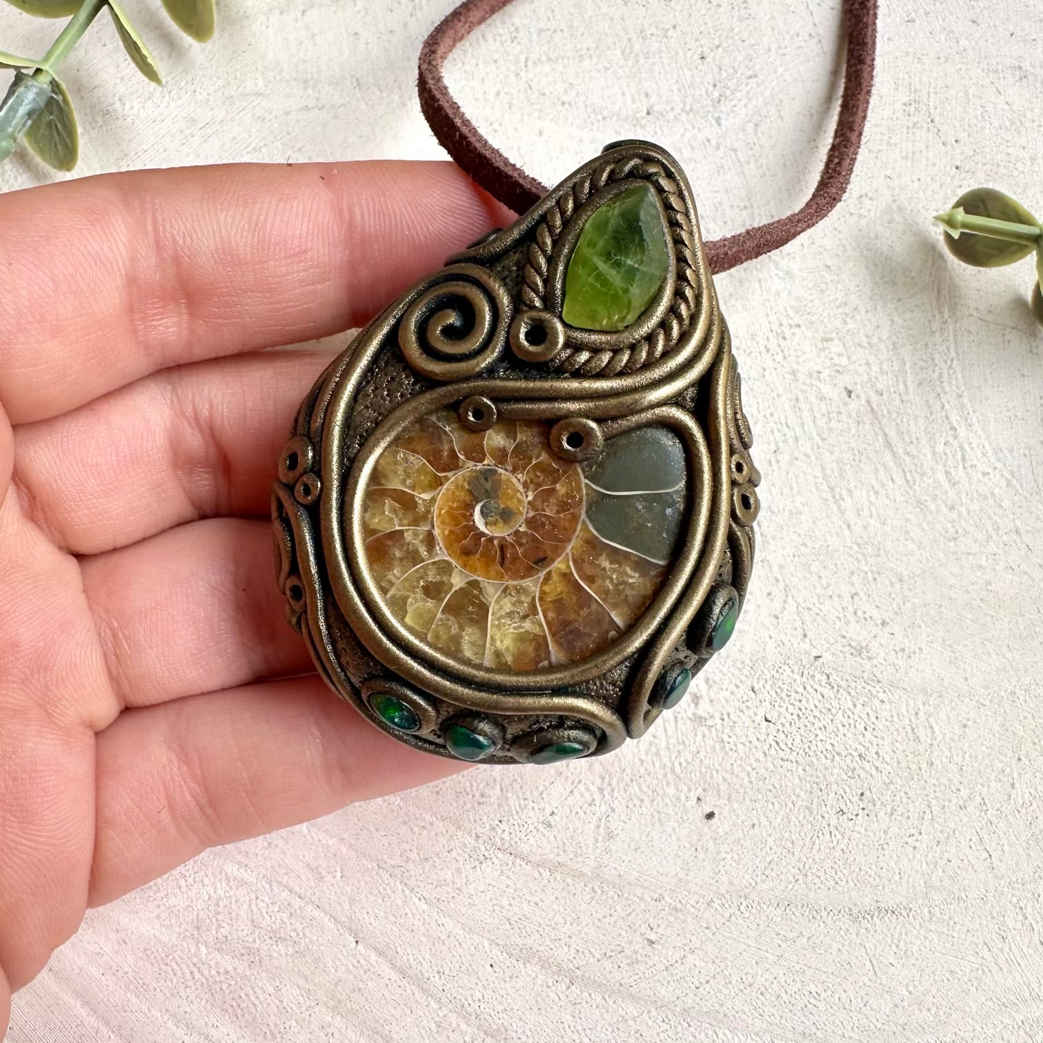Unisex healing crystal necklace featuring ammonite fossil, black Ethiopian opal, and peridot gemstones