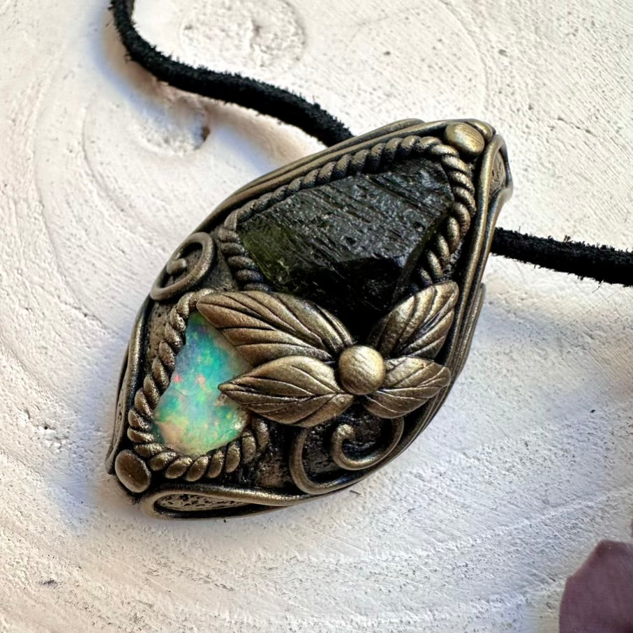 Healing crystal pendant necklace featuring raw green Moldavite and Ethiopian Opal, wearable spiritual talisman jewelry.